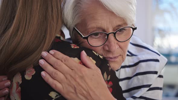 Young Woman Embracing an Elderly Lady. Grief and Bead News, Empathy Concept