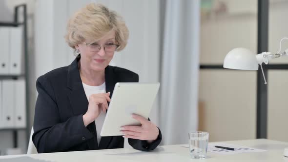 Old Businesswoman Talking on Video Chat on Tablet