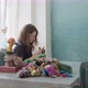 Woman Making Wool Art Doll Toy at Table. Female Sitting and Creating Ooak Doll at Home. Needle - VideoHive Item for Sale