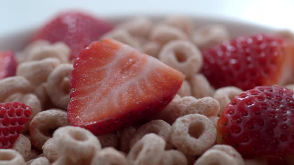 Closeup of milk pouring onto bowl of cereal with strawberries; shot on Phantom Flex 4K at 1000 fps alt