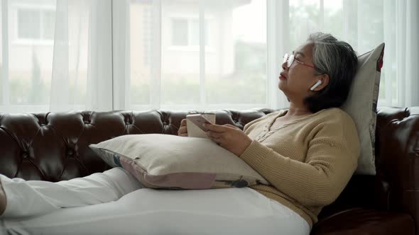 Elderly Asian Using Modern Gadgets