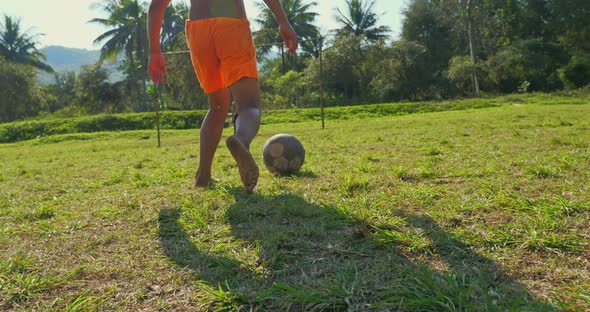 Asian Rural Little Boy Shooting At Goal