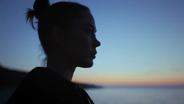 Dark Silhouette Face Woman Standing in Front Evening Sky Close Up