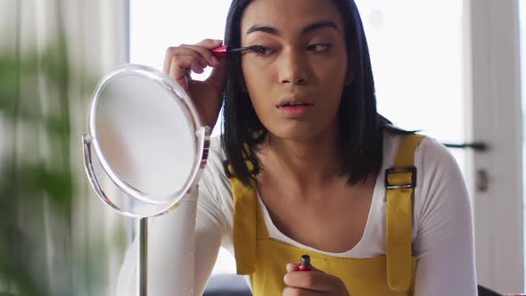 Mixed race gender fluid vlogger recording a make up vlog at home
