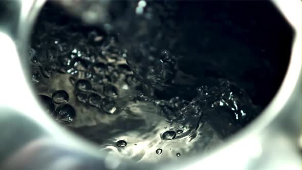 Hot Water with Air Bubbles Pours Into the Mug