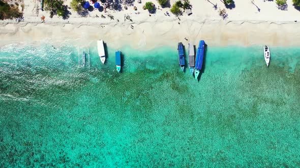 Aerial drone shot texture of idyllic resort beach vacation by blue ocean and white sand background o