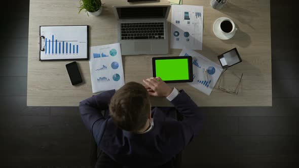 Sad Businessman Scrolling Pages on Green Screen Tablet, Depression, Top View