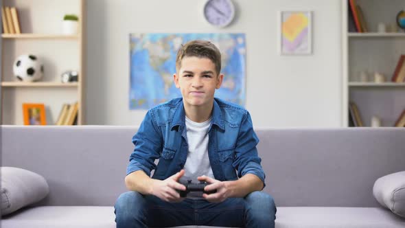 Overemotional Teen Boy Losing Video Game, Throwing Joystick Away, Awkward Age