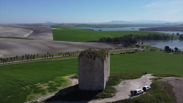 Aerial drone orbiting historic ruin tower in beautiful nature landscape scenery, Spain