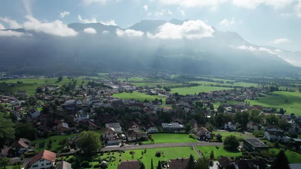 Aerial View of Liechtenstein with Houses on Green Fields in Alps Mountain Valley