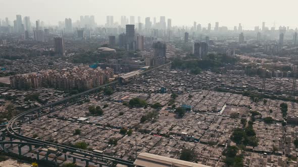 Aerial view of both high-rise buildings and slums in Mumbai city, Maharashtra.