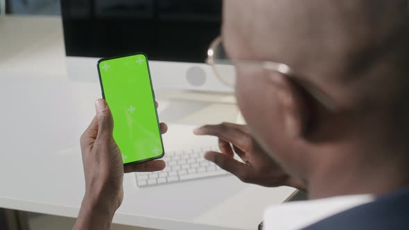 Close Up of Africanamerican Man Using Smartphone with Chroma Key Green Screen Tap to Click on Centre