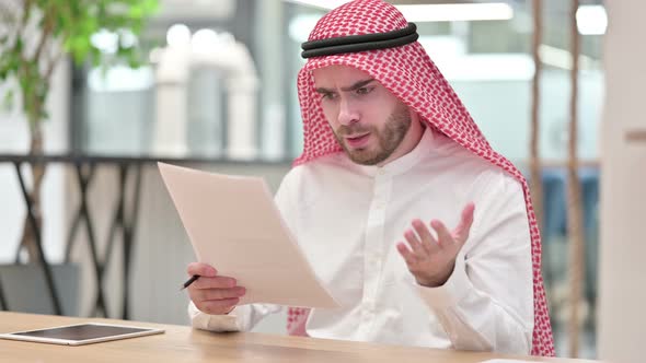 Upset Arab Businessman Having Loss on Documents in Office 