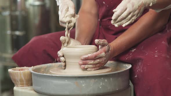 Joint Work Production of Handmade Tableware the Young Couple Potter Makes a Pitcher Out of Clay Top