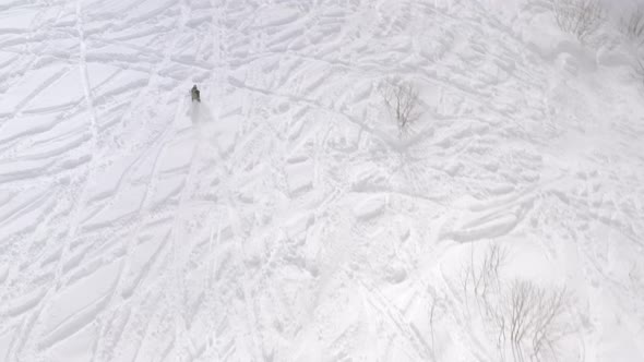Skier Riding on Mountain Ski From Snowy Slop at Winter Resort. Aerial View 