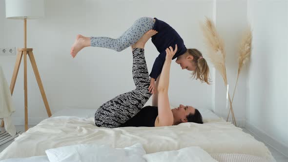 Little Girl with Mother Enjoying Workout at Home