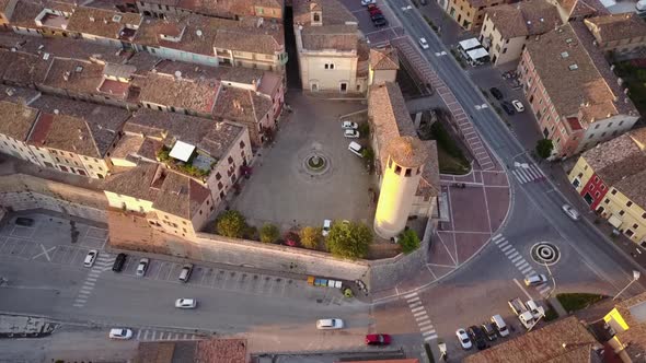 View of an old medieval city by drone, crossed by a road. Italy