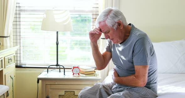 Unhappy senior man suffering from stomach ache