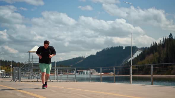 Young fat man is jogging training loses weight