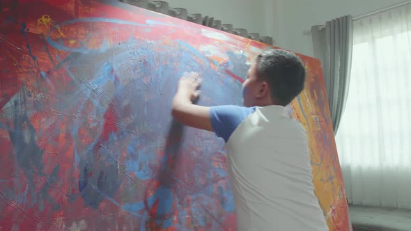 Boy Draws With His Hands On The Large Canvas