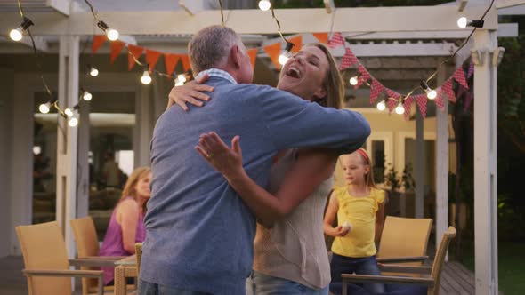 Senior man hugging his daughter outdoors