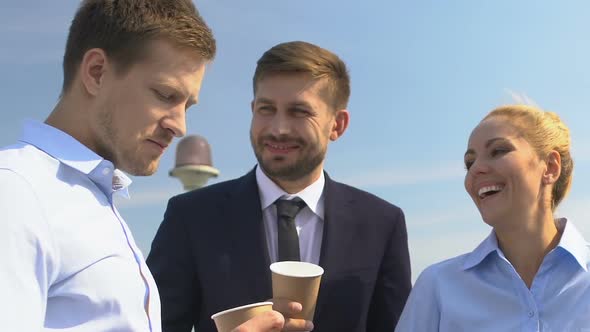 Kind Boss Drinking Coffee With Colleagues, Communicating and Laughing Outdoor