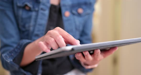 Close up of woman using digital tablet