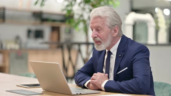 Senior Old Businessman Doing Video Chat on Laptop