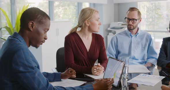 Young Multiethnic Team Brainstorming in Modern Coworking Office