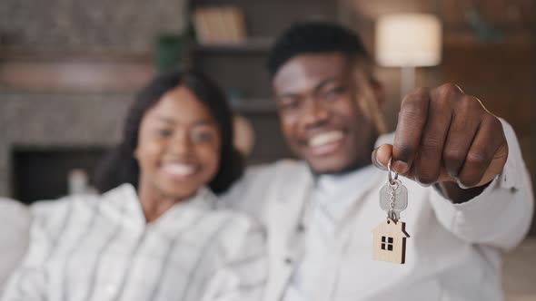 Blurred Unfocused View African American Married Couple Newlyweds Wife and Husband Holding Keys to