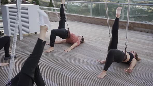 People doing yoga together in Revolved Downward Facing Dog pose