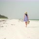 Young Woman Walks Barefoot On Beach Along Ocean - VideoHive Item for Sale