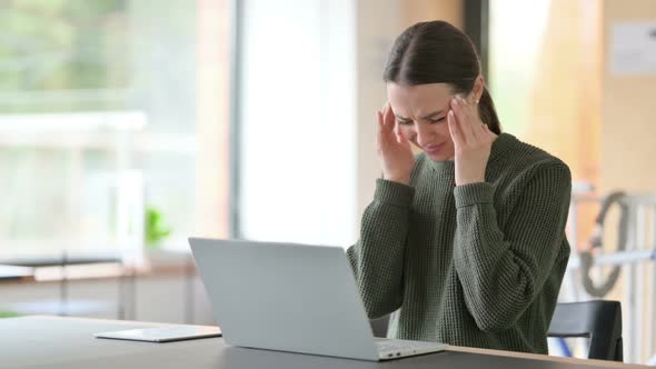 Young Woman with Laptop Having Headache