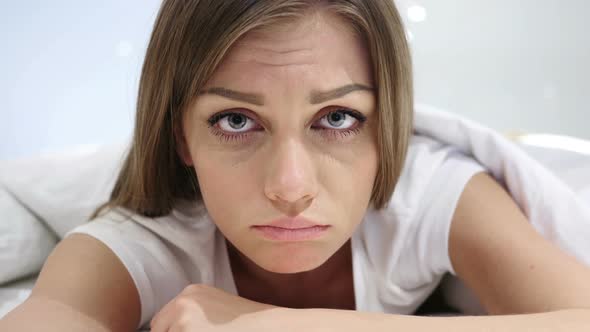 Sad Woman Feeling Frustrated, Lying in Bed, Tears in Eyes