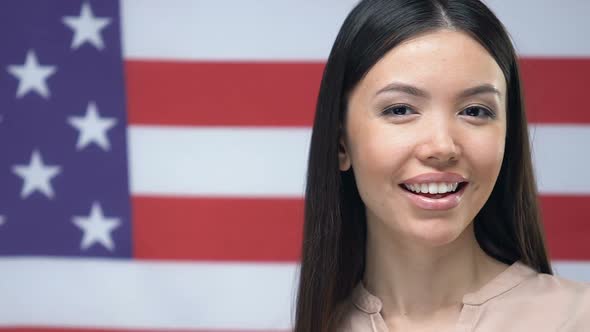 Attractive Lady Showing Credit Card on American Flag Background, Money Transfer