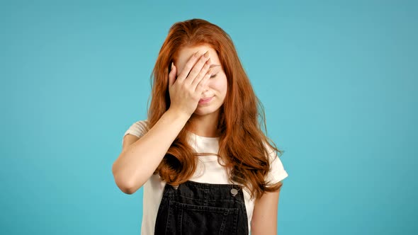 Portrait of Young Woman Doing Facepalm Gesture, Like No, I Forgot. Unhappy Woman with Long Hair