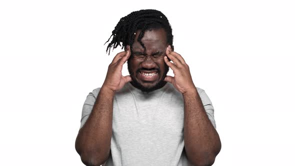 Portrait of Sick Afro Man in Basic Tshirt Rubbing Temples and Touching Forehead Because of Headache