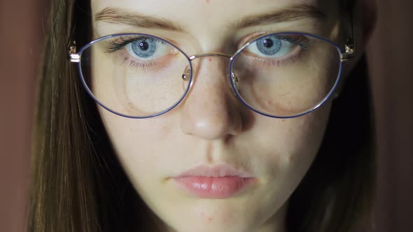 Closeup Eyes of a Teenage Girl with Glasses Looks at the Monitor Plays a Game Reads Studies