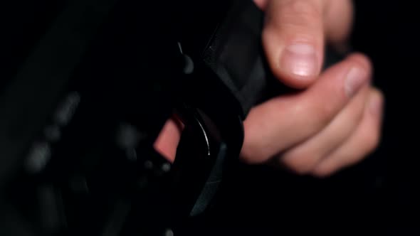 Man in a multicam on a black background pulls the trigger of a carbine