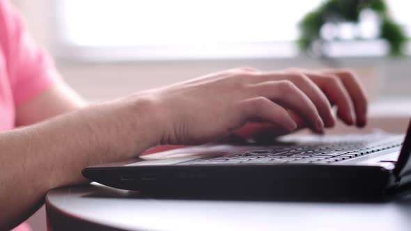 Hands of a Man Who Works on a Laptop Camera Tracking Close Up