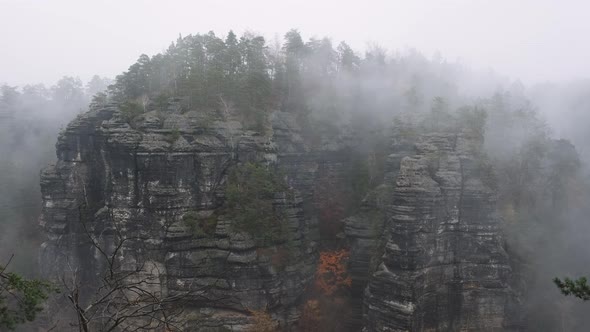 Mystical landscape Forested Mountains Bohemian Switzerland. Rocks in foggy