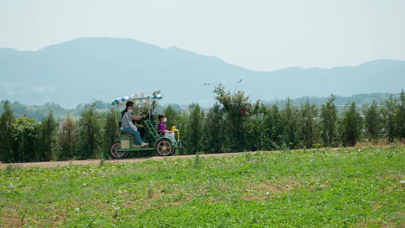 Family Enjoying Riding On Four-Wheeled Bike Touring Around At Anseong Farmland In Gyeonggi-do Provin