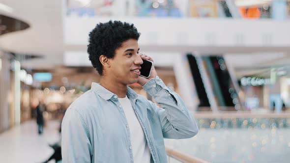 African Dominican Guy Surprised with Phone Number Ringing Looking at Screen Man Answering Unexpected