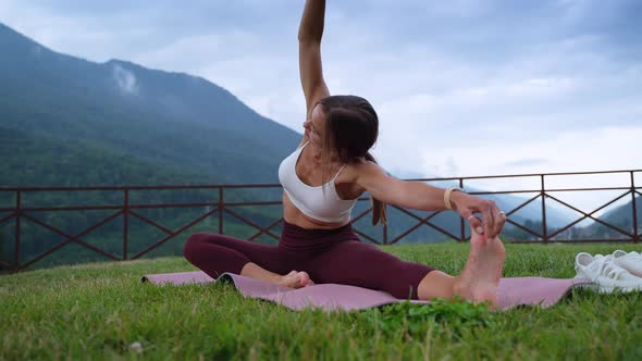 Young Slender Woman is Doing Stretching Workout in Nature Sporty Activities