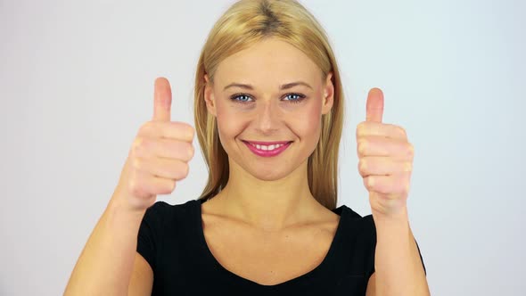 A Young Attractive Woman Shows Thumbs Up To the Camera - Closeup on the Hand - White Screen Studio