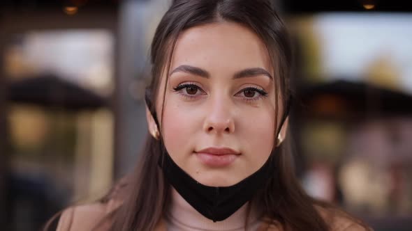 Close Up of Woman Take on Face Mask Outdoors