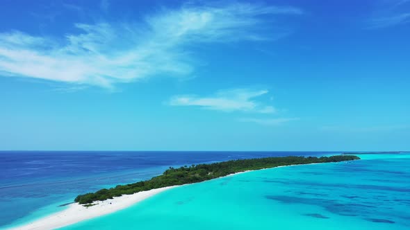 Wide aerial travel shot of a white paradise beach and blue water background in hi res 4K