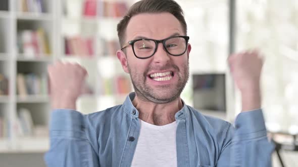 Excited Young Man Celebrating Success