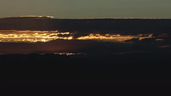 Golden Sunrise Behind Thin Layer of Clouds Timelapse Tight Shot