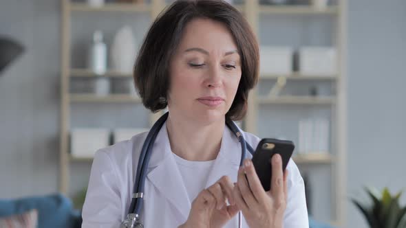 Old Lady Doctor Browsing Smartphone